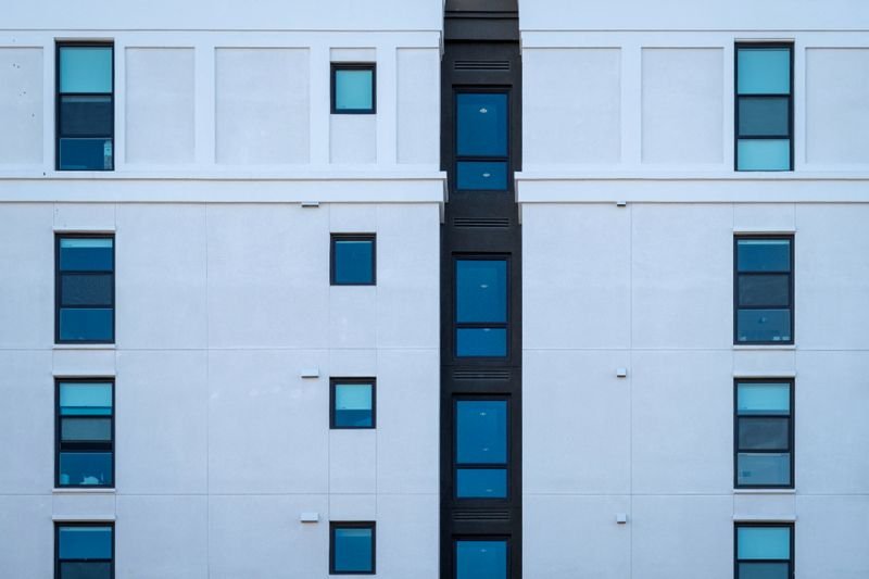 Completed render finish across an insulated residential facade