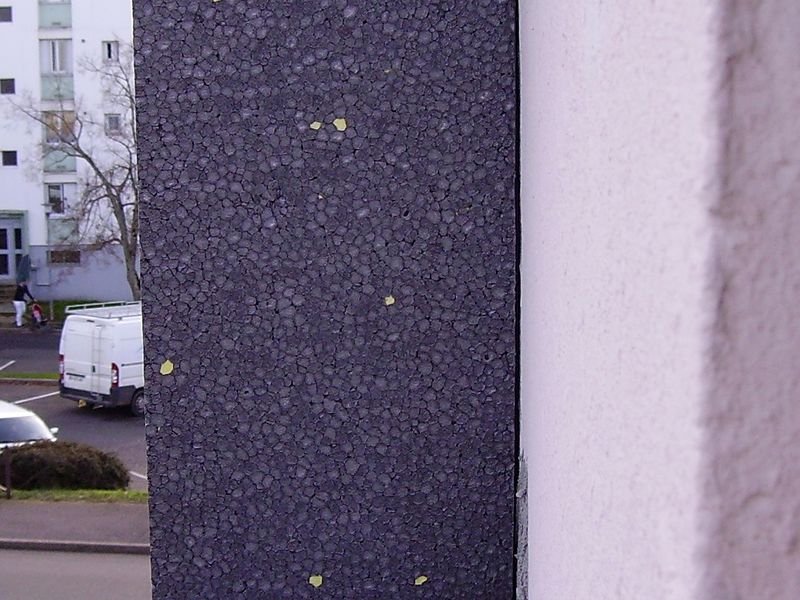 External wall insulation being installed on the corner of a house